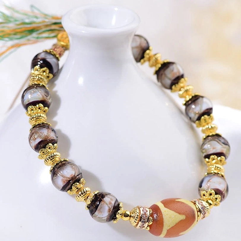 Dzi blessing bracelet overhead product shot showing all bead elements and adjustable sizing feature