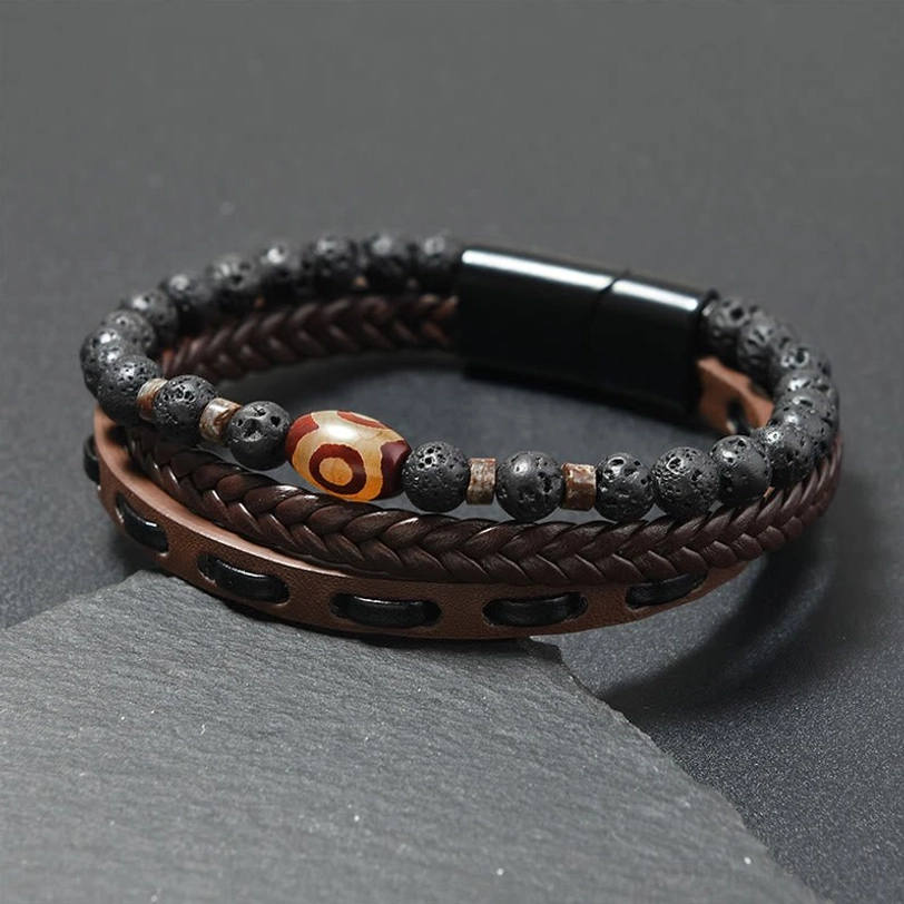 Coffee brown leather Nine-Eye Dzi bead protection bracelet with lava rock and magnetic clasp on stone mat