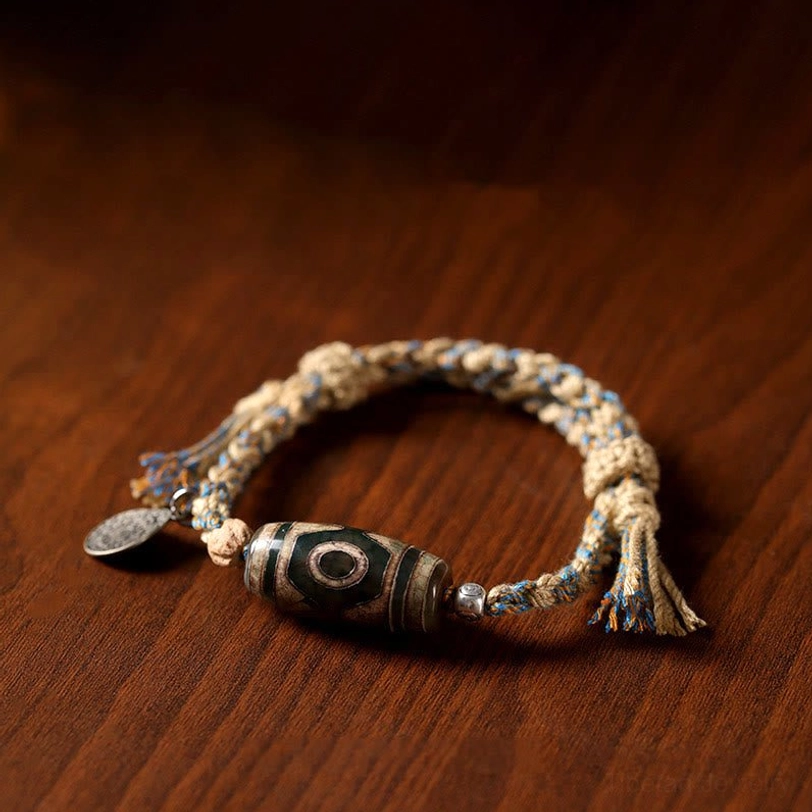 Dzi bead bracelet styled flat lay photography showcasing spiritual jewelry for protection, prosperity, and wellness practices