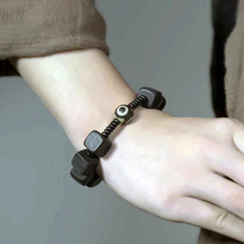 Ebony wood dzi bead bracelet spiritual meaning protection wealth health longevity tibetan buddhist culture symbolism