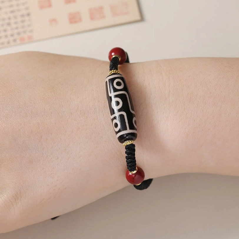 Tibetan nine-eye dzi bead bracelet worn on human wrist showing fit and comfort for daily spiritual wear