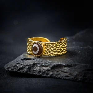 Tibetan Dzi bead copper ring tilted angle showing evil eye symbol and hammered metal finish