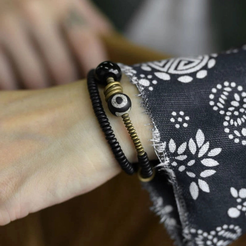 Sacred Dzi bead focal point on double wrap protection bracelet with natural wood beads