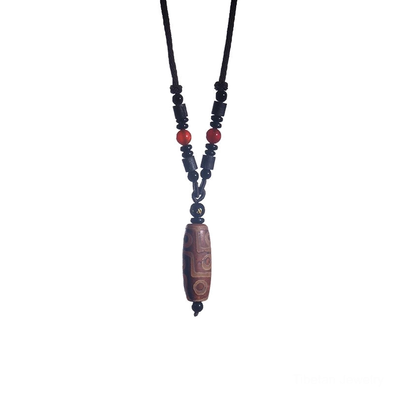 Full-length brown nine-eye dzi bead necklace displayed hanging with beaded black cord and red accents