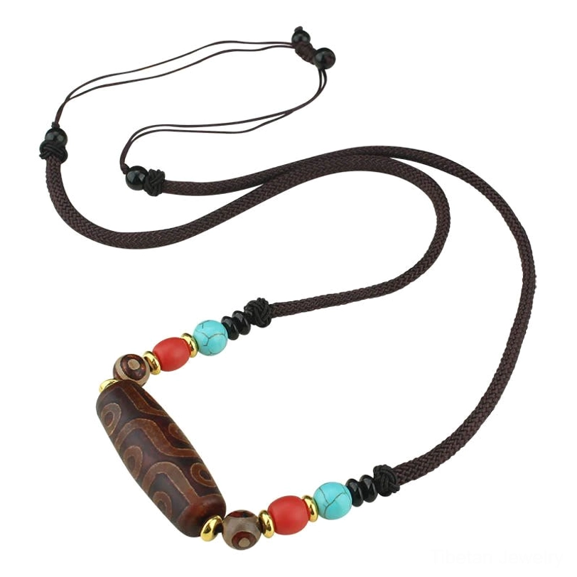 Multiple dzi bead necklace variants arranged together showing nine-eye and three-eye options with different cord colors and bead accents