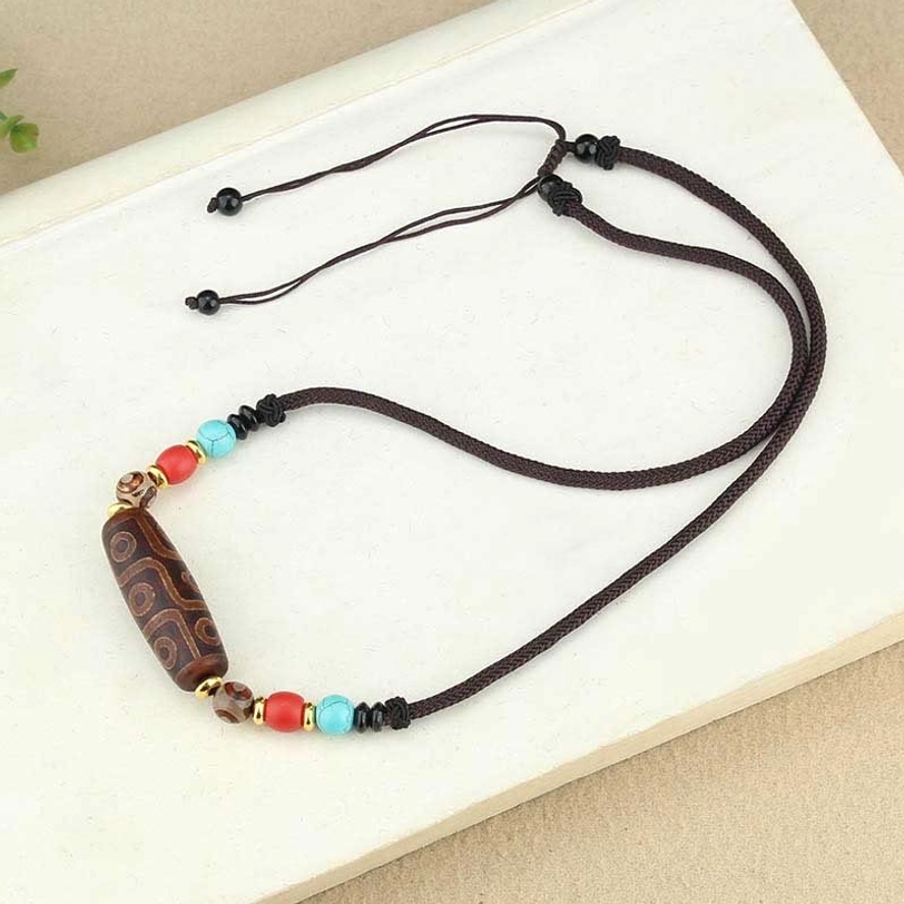 Dzi bead necklace styled on model or display showing how to wear tibetan protection pendant with natural posture