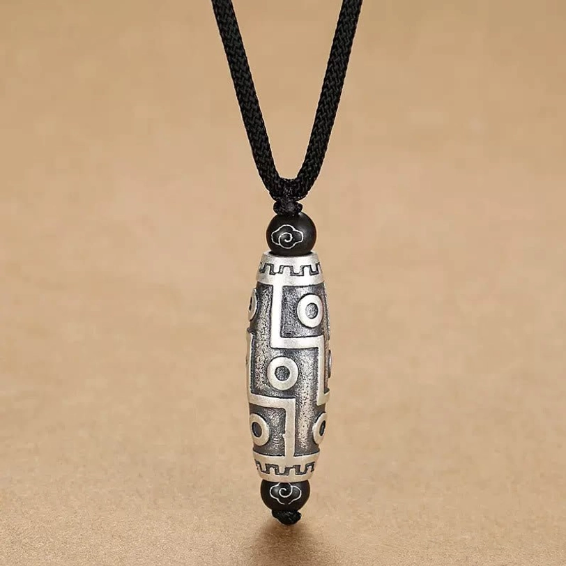 Nine-eye dzi bead tibetan necklace front flat lay clearly showing traditional nine-eye pattern and cloud engravings