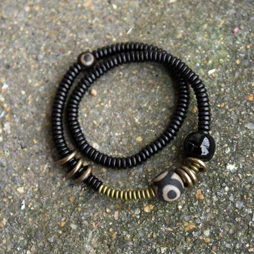 Sacred Dzi bead protection bracelet featuring ebony wood and brass accents - double strand display