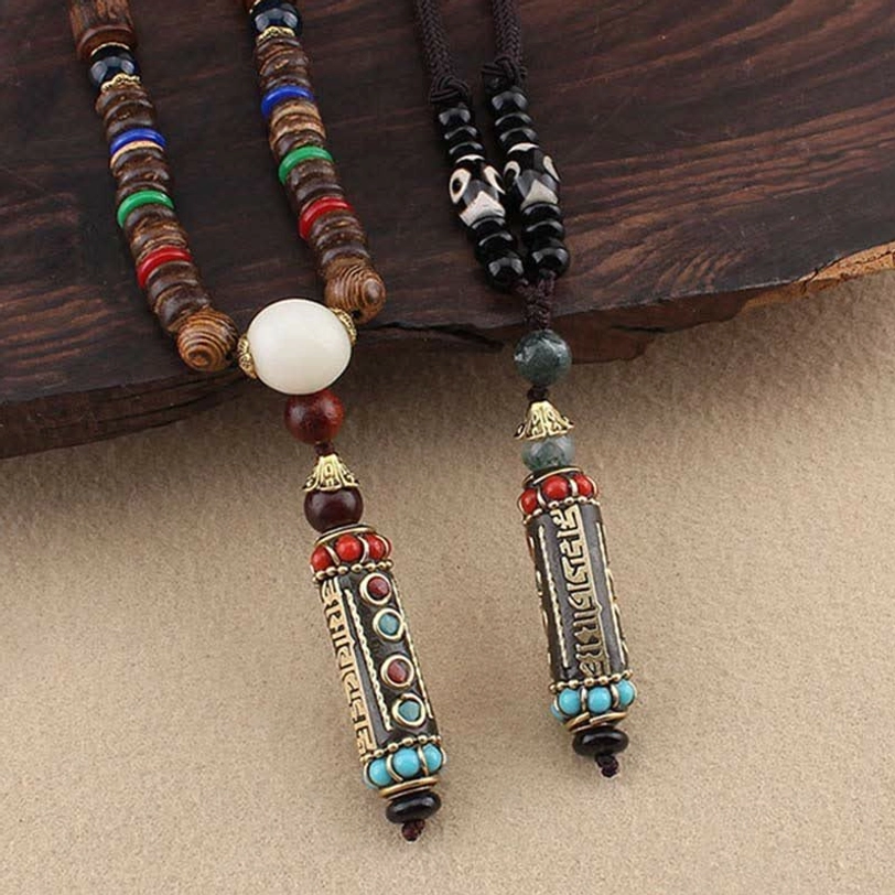 Tibetan dzi bead necklace featuring wenge wood beads, nine-eye dzi bead, and enamel Om Mani Padme Hum pendant