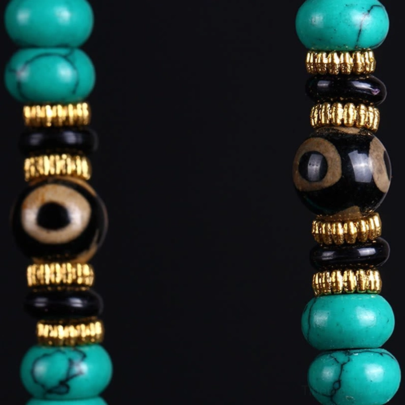Split view mala bead details showing dzi bead with gold spacers and natural veined turquoise beads