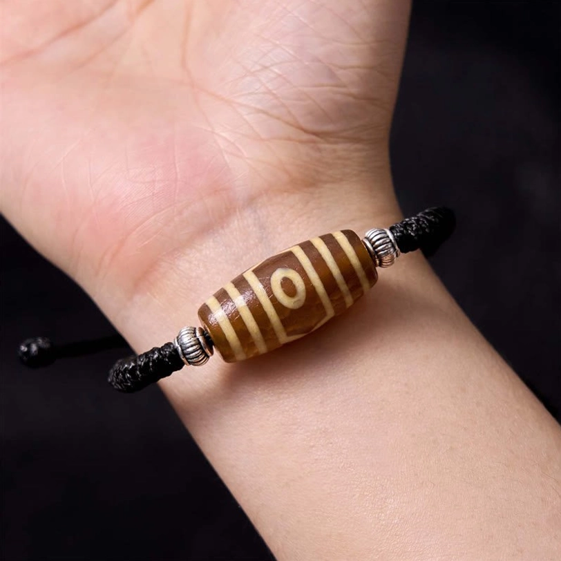 Traditional tibetan dzi bead bracelet care instructions showing proper wearing and maintenance practices