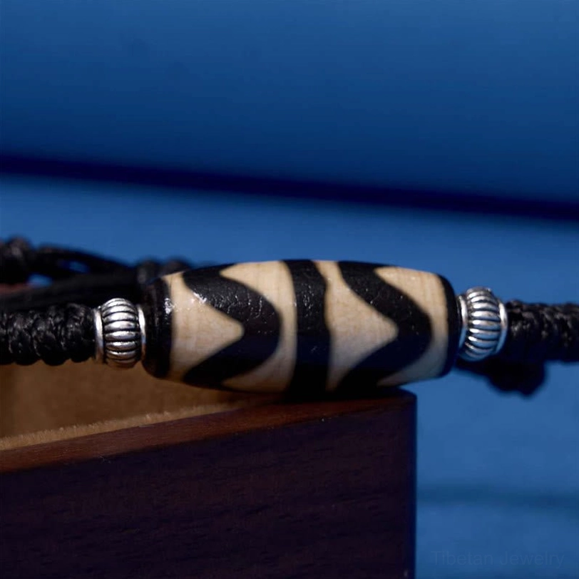 Tibetan dzi bead bracelet sacred himalayan tradition representing authentic buddhist cultural heritage