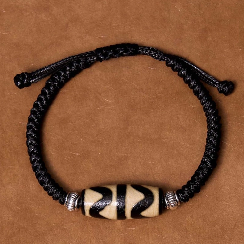 Tibetan dzi bead bracelet protective amulet showing dharmapal deity attraction and negative energy purification