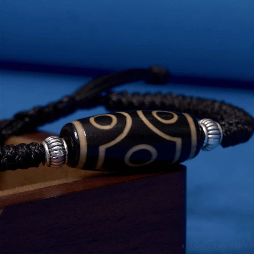 Tibetan dzi bead bracelet worn by spiritual practitioner showing everyday protection talisman use