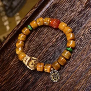 Hand-painted dzi bead and carved fox charm close-up detail shot