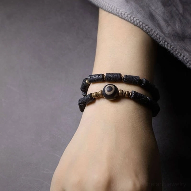 Three-eye dzi lava rock wrap bracelet size options - wrist circumference guide 14-17.6cm in flat lay display