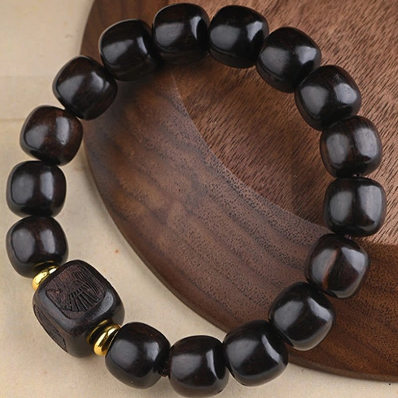 Wooden barrel bead bracelet flat lay displaying smooth dark brown wood texture with metal spacer details
