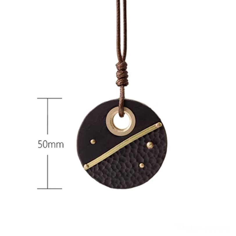 Ebony wood and brass Tibetan spiritual peace pendant showing all design angles and materials