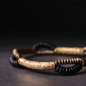 Tibetan ebony wood copper bracelet side close-up view highlighting curved hammered metal bar and beads