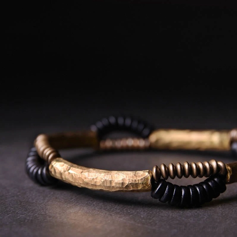 Tibetan ebony wood copper bracelet side close-up view highlighting curved hammered metal bar and beads