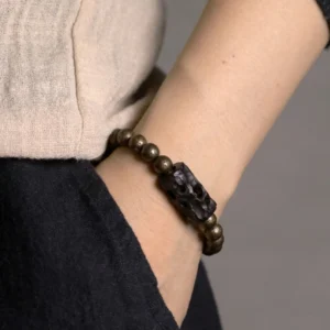 Ebony wood copper beaded bracelet worn on wrist with casual outfit styling on model