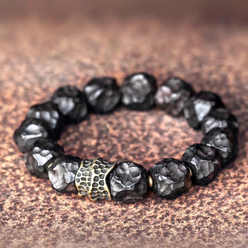 Ebony wood copper couple bracelet with 12mm beads and bronze spacer detail, shown in flat lay against brown leather
