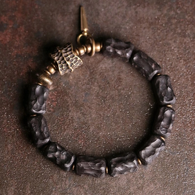 Pair of matching ebony wood copper couple bracelets for partners showing spiritual connection symbolism