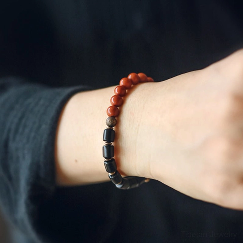 Worn ebony and red jasper healing bracelet on wrist close-up showing everyday slim fit style and comfort wear
