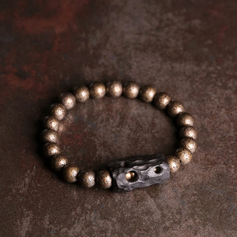 Detailed view of carved ebony wood spacer with twin holes and uniformly finished antique copper beads