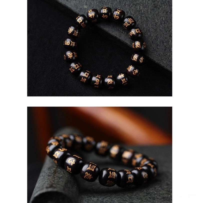 Compact Tibetan ebony wood mantra bracelet with small 12mm beads featuring printed golden Om Mani Padme Hum Sanskrit on dark stone surface