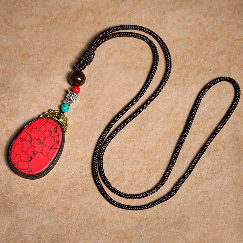 Ebony wood spiritual protection necklace worn styling shot with bohemian accessories