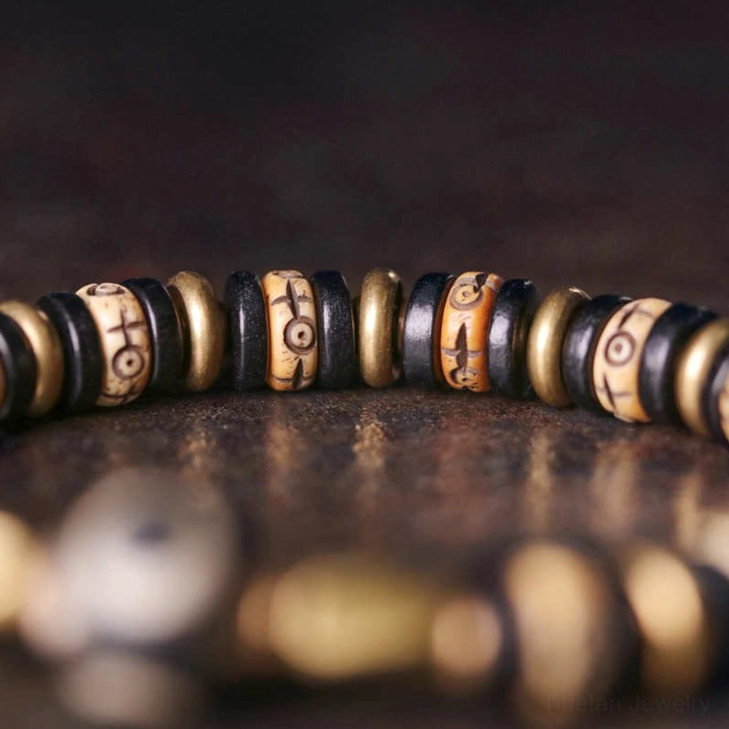 Macro close-up of ebony wood bead texture and aged metal spacers