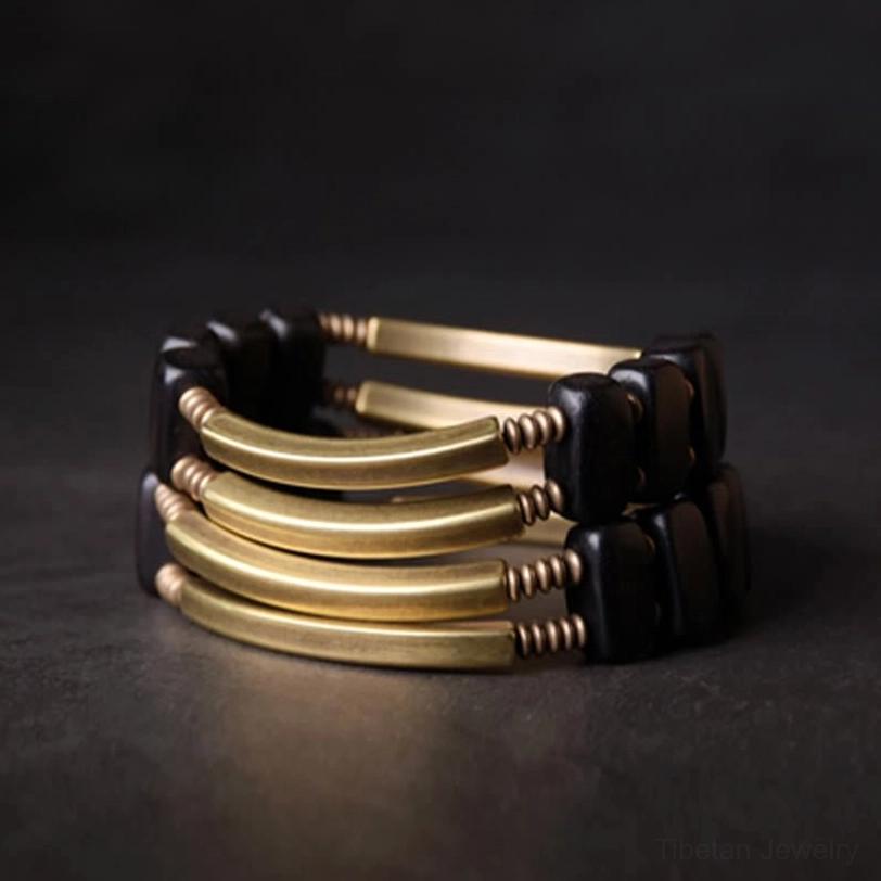 Ebony wood brass abundance bracelet spiritual energy detail, featuring premium natural materials and artisan craftsmanship in macro view