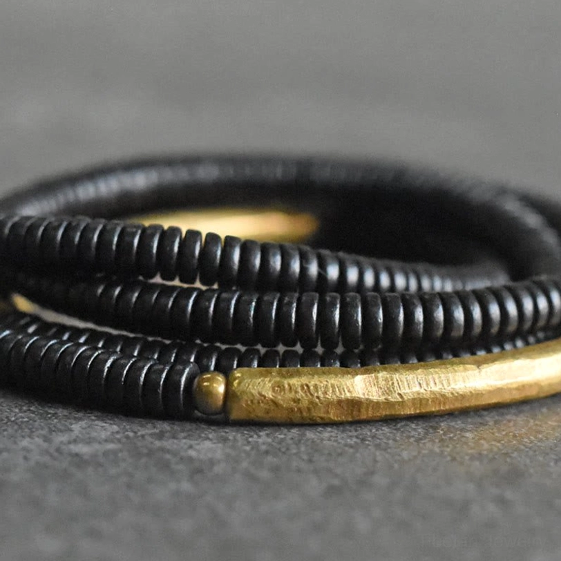 Close-up extreme detail ebony wood brass bracelet tiny beads texture