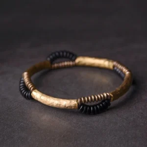 Handmade ebony wood and copper prosperity bracelet flat lay showing hammered metal accents and mixed bead textures