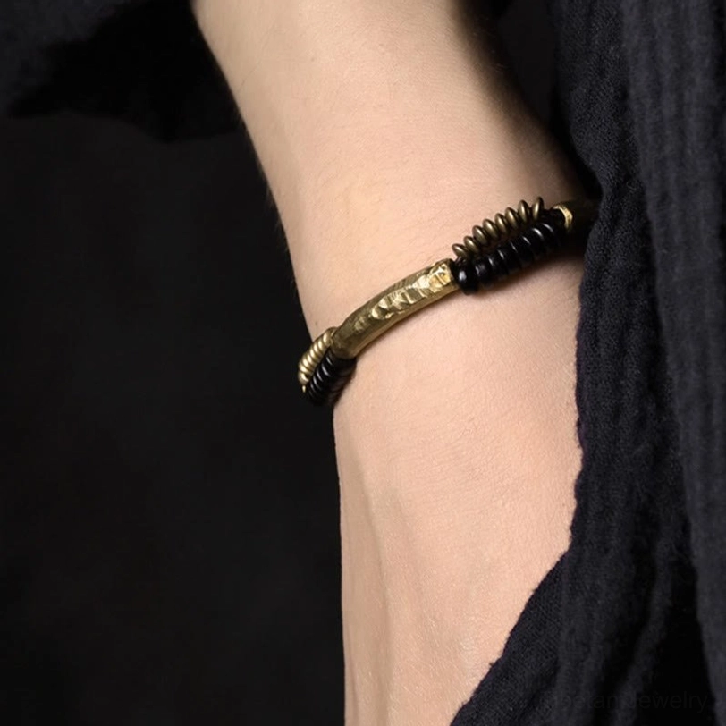 Ebony wood copper bracelet worn on wrist close-up showing fit and design details in wear