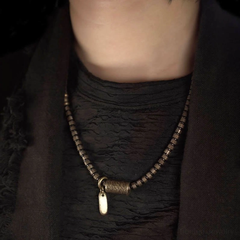 Long ebony wood beaded necklace with copper clasp and hanging tag