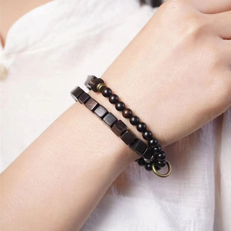 Side wrist wear view of ebony wood double wrap bracelet in daily use showing the two-layer wrap style and dark wood finish