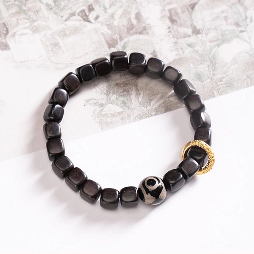 Ebony wood dzi bead protection bracelet fitted on wrist showing side profile and bead detail