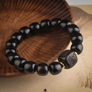 Lucky treasure ebony wood bead bracelet overhead view showing polished dark wood finish and carved accents