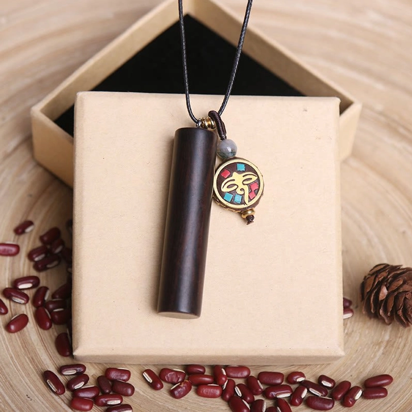 Round enamel dzi charm ebony wood pendant necklace with black cord on wooden gift box setting