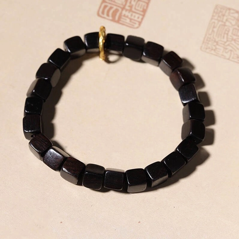 Minimalist ebony wood square bead bracelet flat lay with deep brown wood tone and simple design