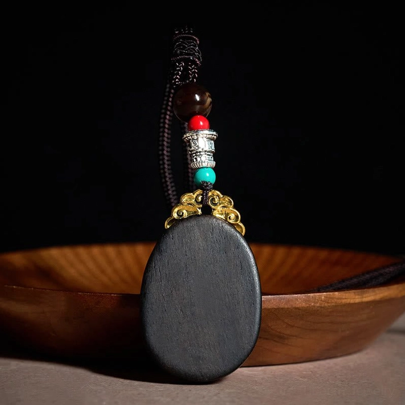 Ebony wood tribal oval necklace back view showing natural wood texture on weathered surface