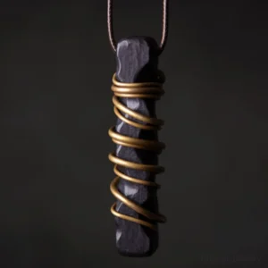 Handcrafted ebony wood Tibetan zen circle pendant with brass wire wrapping, close-up front view showing natural wood grain texture and metal detail