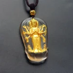 Eight-armed Avalokitesvara Guanyin Buddha gold-plated Liuli crystal pendant with brown necklace cord and gold accent bead, frontal studio view