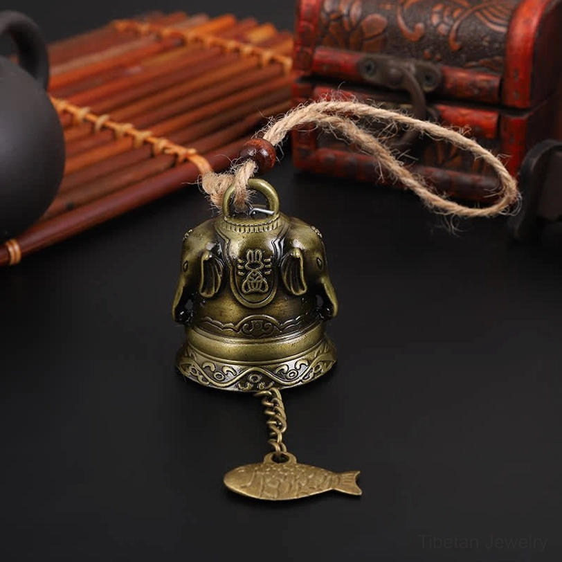 Elephant and Buddha embossed bronze Tibetan wind chime with detailed religious motif carvings and fish pendant