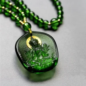 Emerald green Liuli glass Tara pendant with gold halo and Buddha relief, handcrafted crystal jewelry