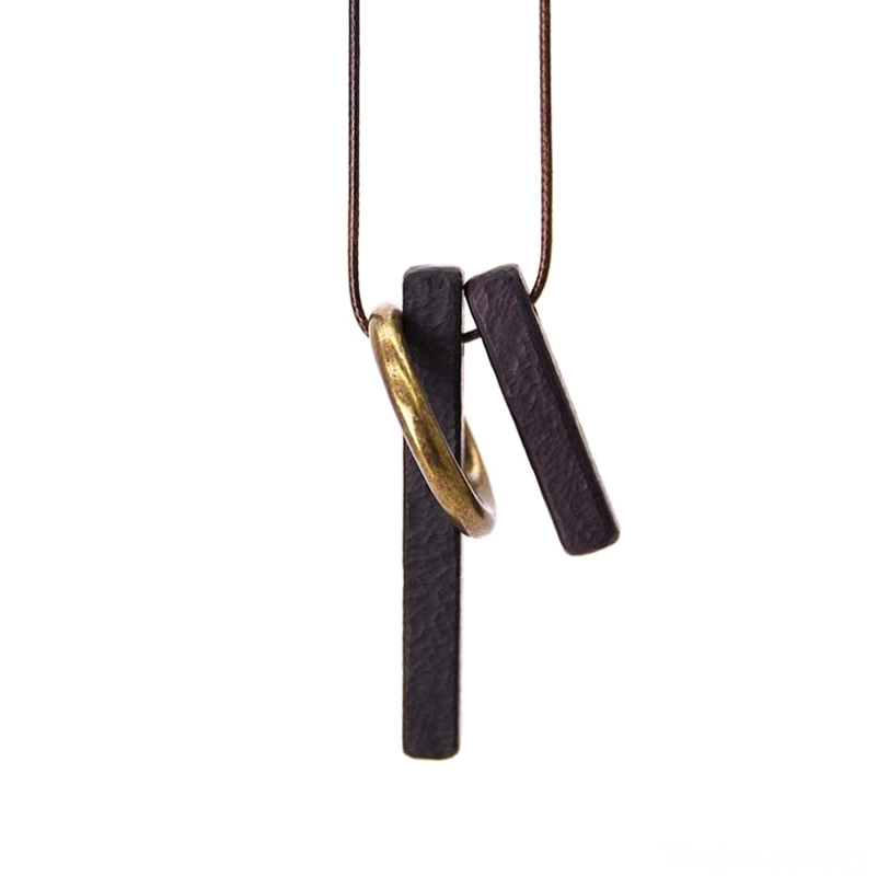 Enso zen circle ebony wood pendant front close-up with brown waxed cord and brass hardware