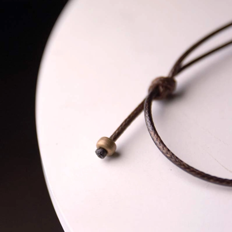 Enso zen circle ebony necklace product photography complete view with waxed cord