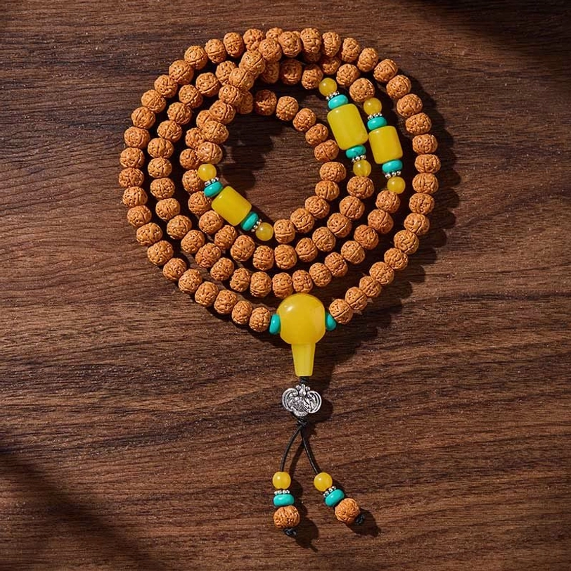 Evergreen through hardship three-eye dzi bead mala, representing resilience and spiritual strength through life's challenges